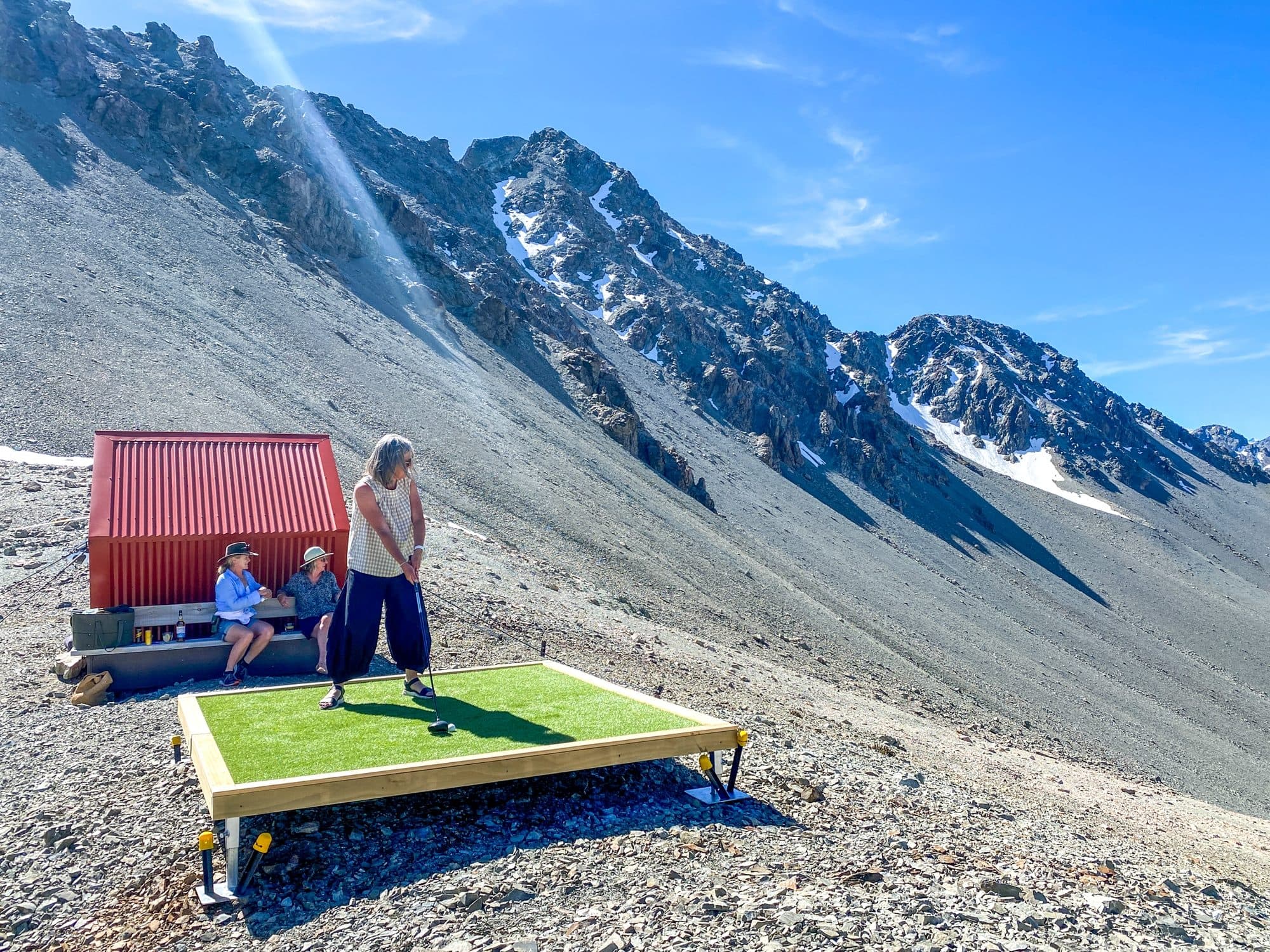 A tee on a scree slope high in the Mackenzie, the helicopter hut behind