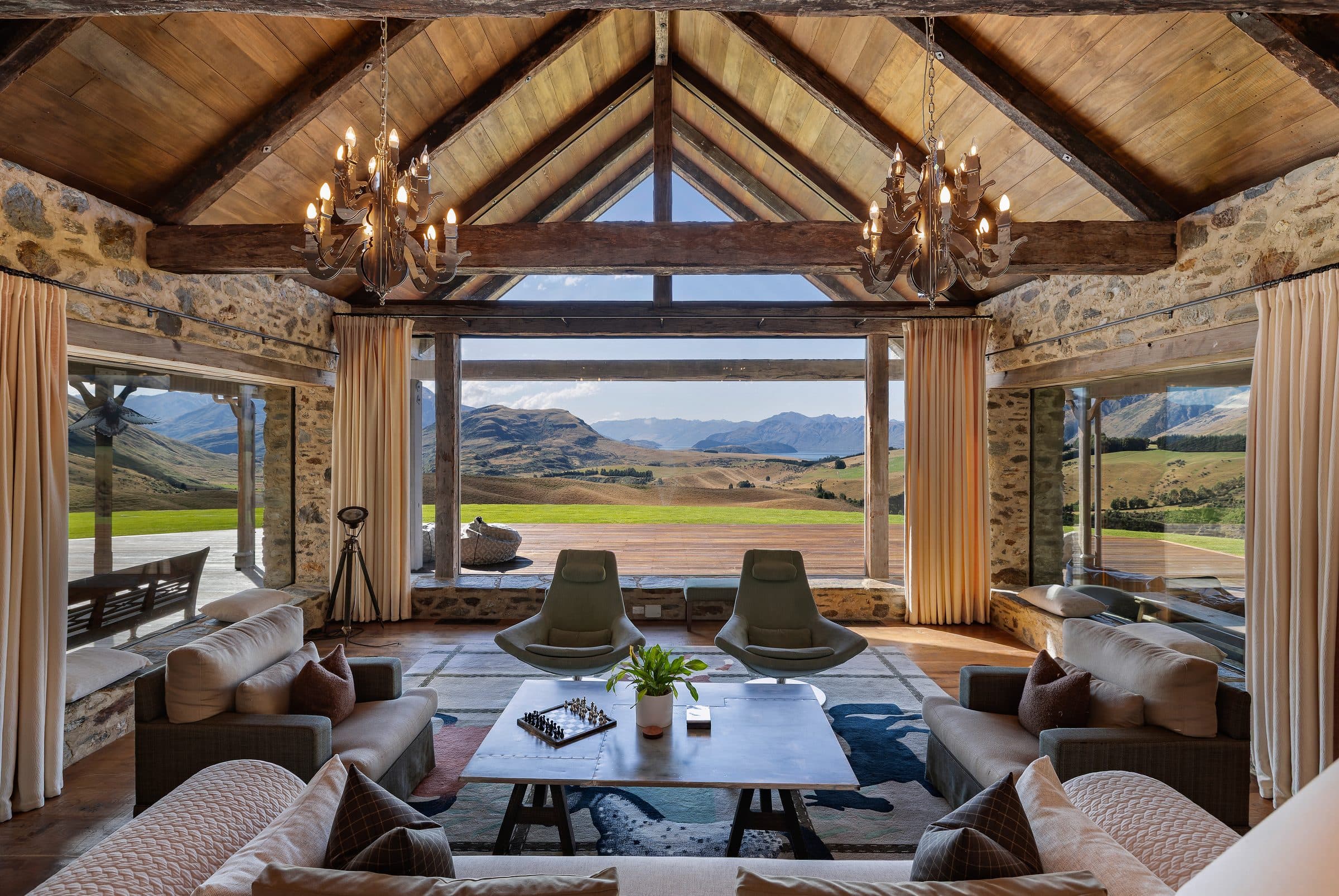 The great room at Mahu Whenua opening through timber and glass to the high country