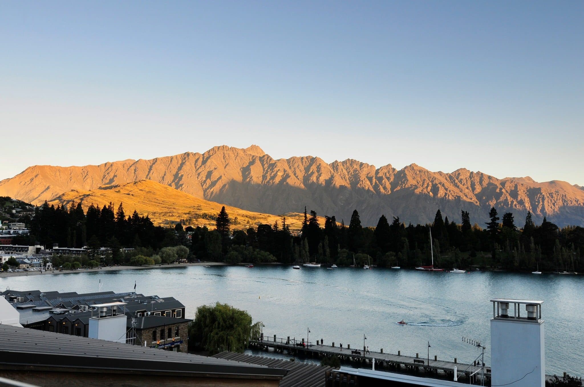 Eichardt’s on the Queenstown lakefront with the Remarkables glowing at sunset across the bay