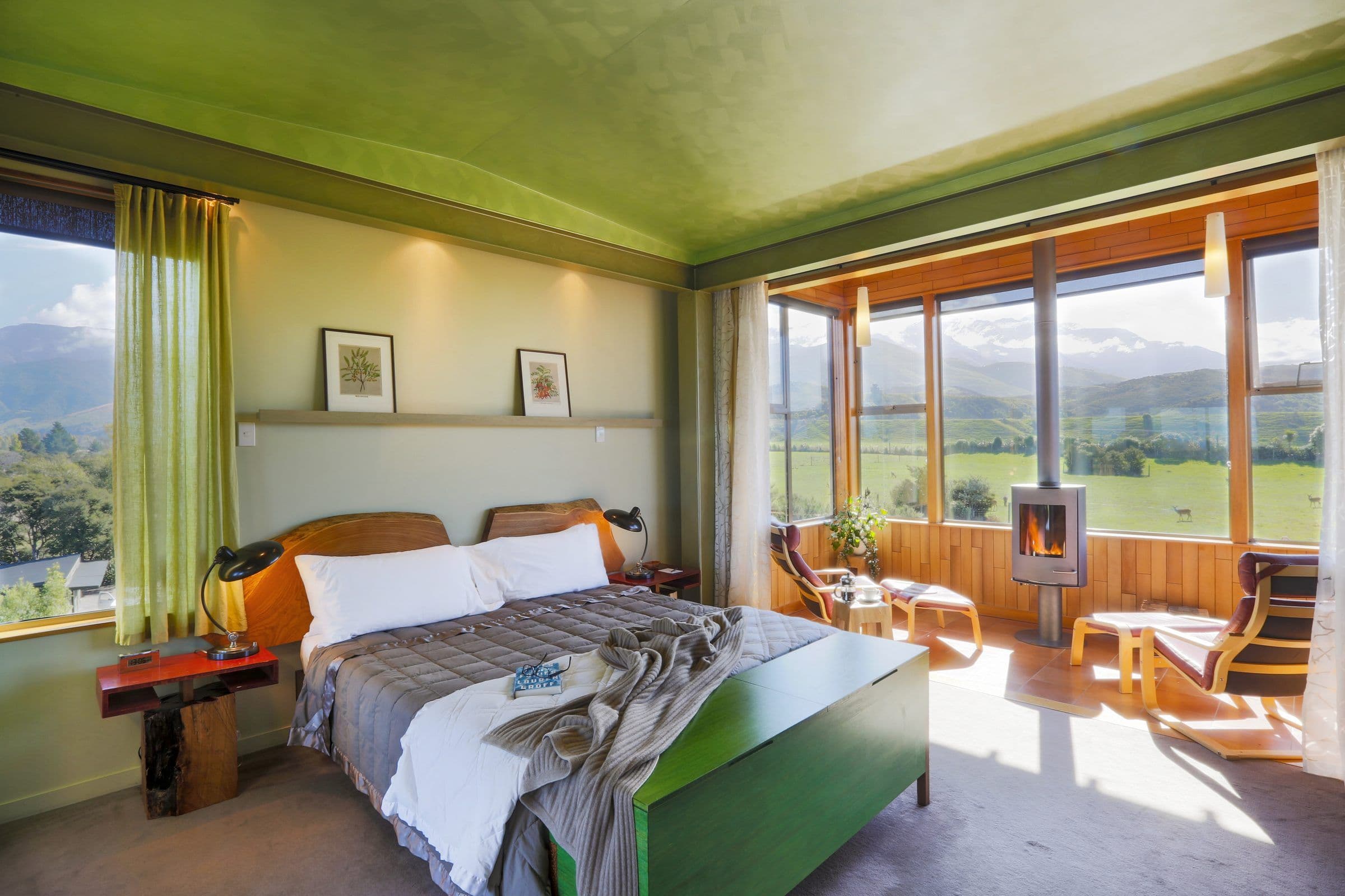 A Hapuku tree house suite raised among branches with the Kaikōura ranges beyond