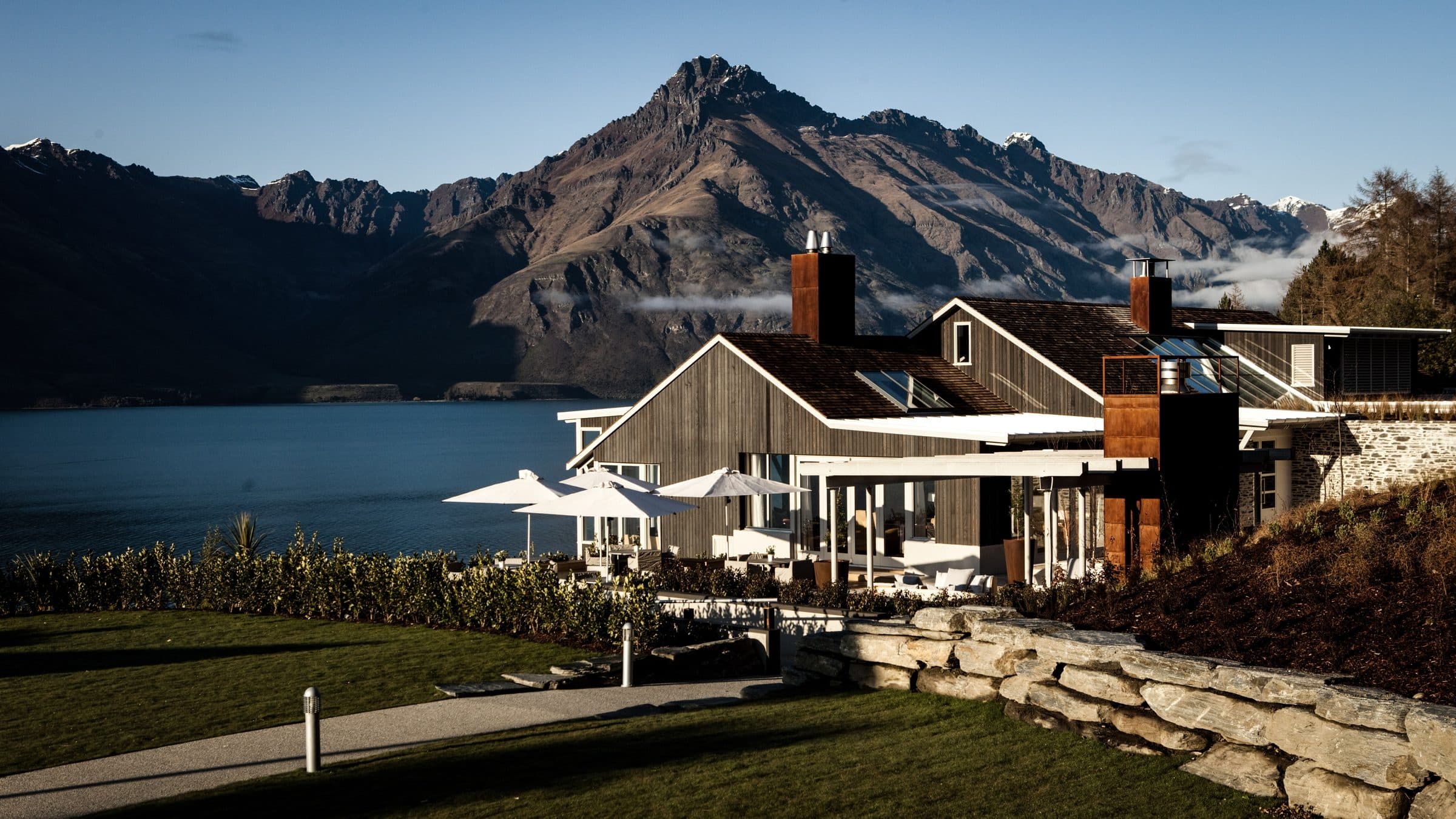 Matakauri Lodge on the shore of Lake Wakatipu with the Remarkables rising behind